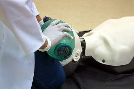 Using a Breathing bag (Ambu) by a student on a simulation dummy during basic life support with an automatic external defibrillator. Simulation training scenarioの写真素材