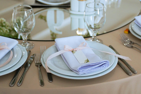 Empty Wedding Reception Hall Table Setting With glasses and Platesの写真素材