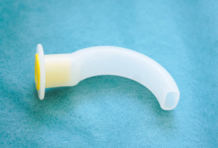 An oropharyngeal airway (OPA) tube is used in emergency medicine and anesthesia to maintain airway patency in unconscious patients. Medical equipment for airway managementの写真素材