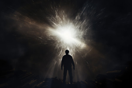 Silhouette of a businessman looking at a light source on a dark backgroundの素材