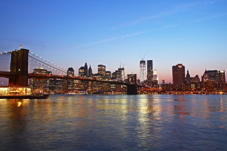 Beautiful view of Manhattan skyline and Brooklyn bridge at sunsetの写真素材
