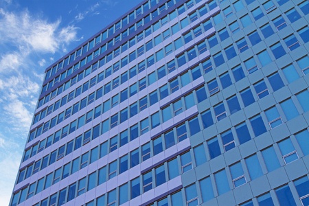 clouds reflection in glass wall of building