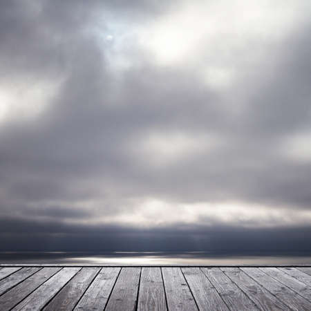 wood floor and somber sky and seeの写真素材