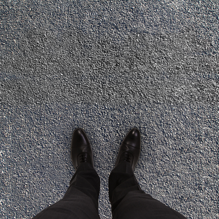 man feet on the asphalt road