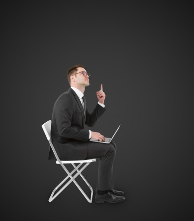 businessman sitting on chair with laptopの写真素材