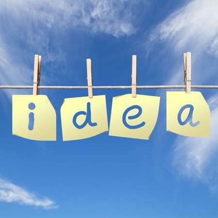 idea word written on sheets of paper on sky backgroundの写真素材