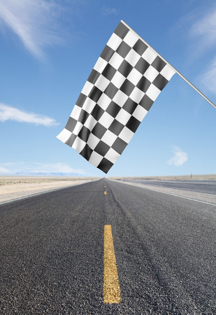 road with yellow arrow with Checker Flagの写真素材
