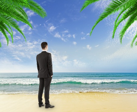 businessman looking on the beachの写真素材