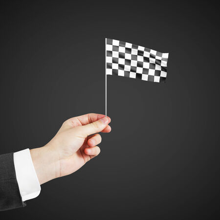 Checkered flag in hand isolated on white backgroundの写真素材