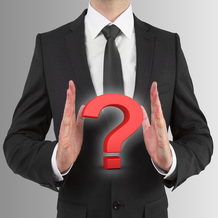 businessman holding red question markの写真素材