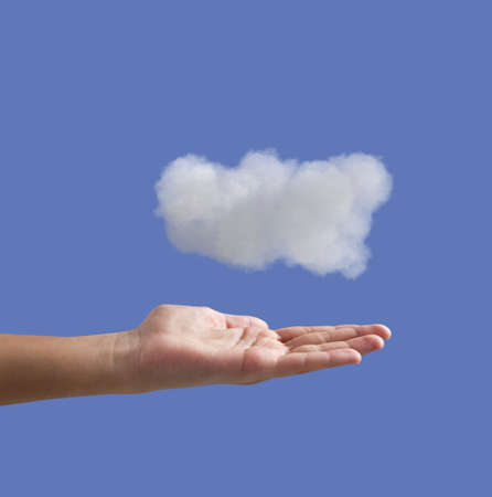 hand and cloud on a blue backgroundの写真素材