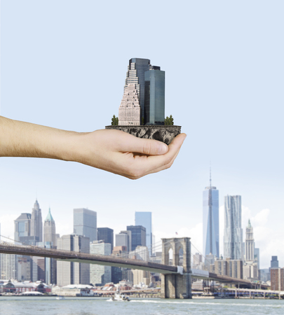 hand holding skyscraper, close upの写真素材