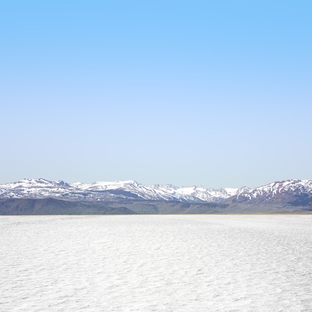 Desert with a blue cloudy sky, close upの写真素材