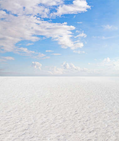 Desert with a blue cloudy sky, close upの写真素材
