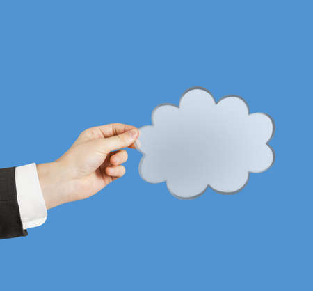 hand holding cloud on a blue  backgroundの写真素材
