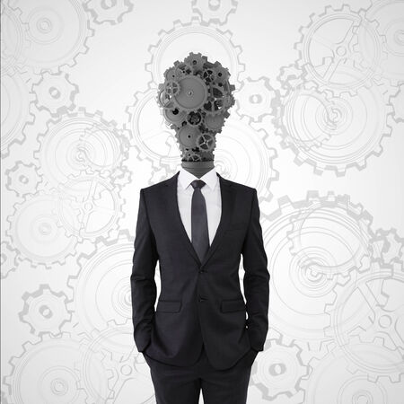 businessman with lamp-head in form gearsの写真素材