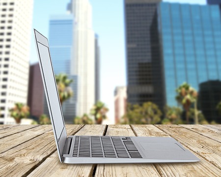 laptop standing on pier and city backgroundの写真素材
