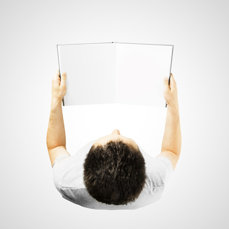 man holding a blank book on a blue backgroundの写真素材