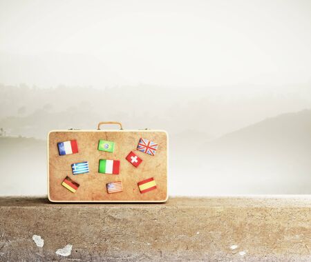 leather  travel bag with many flags, close upの写真素材