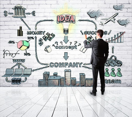 businessman drawing interaction of money and successの写真素材