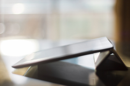 Digital tablet in a room at sunsetの写真素材