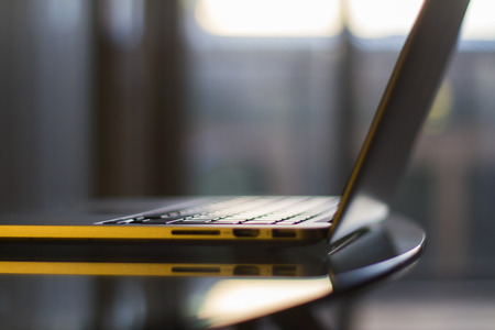 Glass table with modern laptopの写真素材