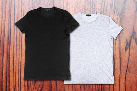 blank t-shirts on the background of wooden wallの写真素材