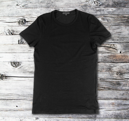 Blank black t-shirt on a wooden surfaceの写真素材