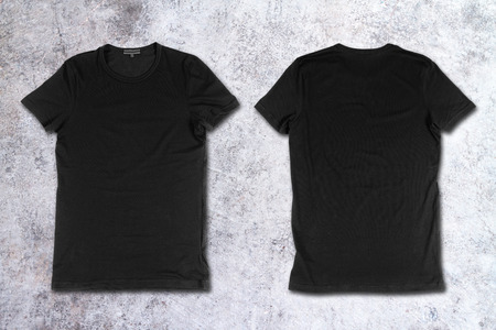 Blank black t-shirts on a concrete surfaceの写真素材