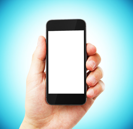 hand with empty cell phone on blue backgroundの写真素材