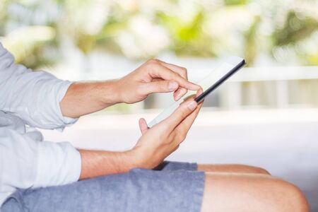 a man using a digital tablet outdoors