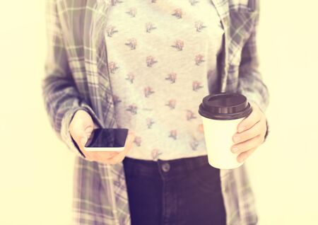 Girl with cell phone and coffeeの写真素材
