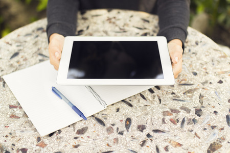 Girl with digital tablet and notebook
