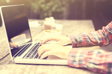 woman typing on a laptop at sunriseの写真素材