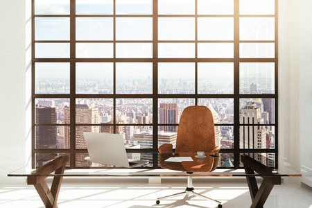 workplace in a white modern interior with city viewの写真素材