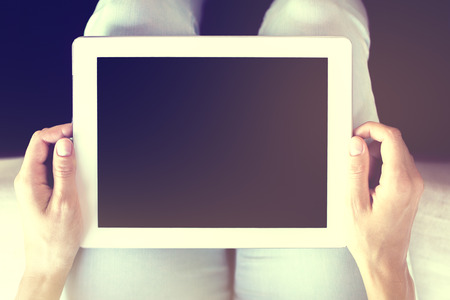 Human hands holding digital tablet