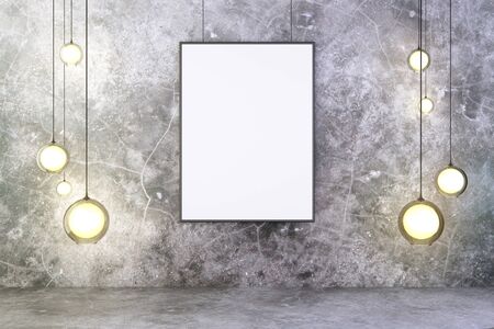 Blank frame with lightbulbs in a concrete roomの写真素材