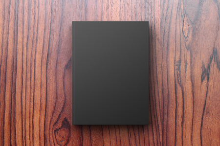 Black diary on a wooden table, mock upの写真素材