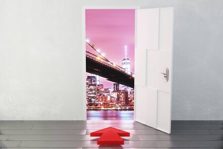 Open door in a city with a red arrow pointing in the directionの写真素材