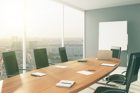 Light conference room with furniture, blackboard and city viewの写真素材