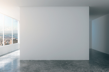 Empty loft room with white walls, city view and concrete floorの写真素材