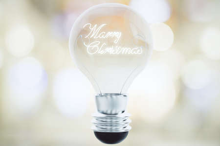 Merry Christmas concept with light bulb and merry christmas phrase insideの写真素材