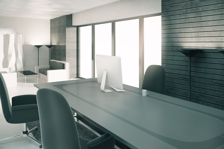 Modern sunny loft office with furniture and computerの写真素材