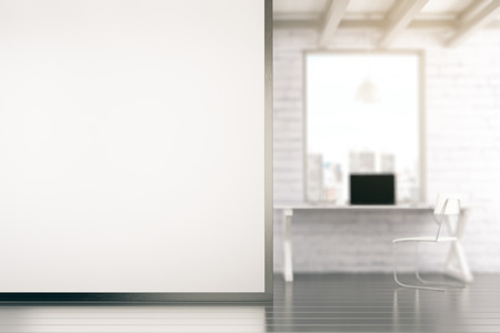 Loft style office with blank white wall with copyspaceの写真素材