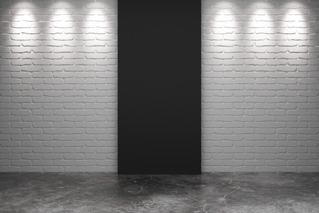 Black part of white brick wall with concrete floor in empty roomの写真素材
