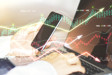 Double explosure with business chart and businessman with smartphone and laptop