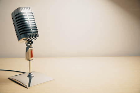 Vintage microphone on white wooden tableの写真素材
