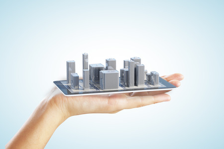 3D city buildings on smartphone and man handの写真素材