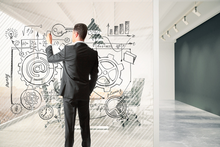 Man draws business plan on a glass partition in the meeting room, business conceptの写真素材