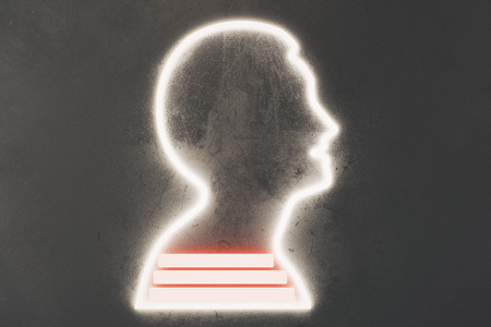 Man silhouette on grey concrete wall and booksの写真素材